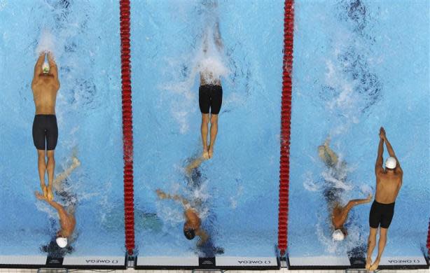 Swimmers from Australia (L), the U.S. (C) and France compete during the men's 4 x 100m freestyle relay final at the London 2012 Olympic Games at the Aquatics Centre July 29, 2012.