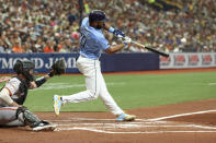 Tampa Bay Rays' Amed Rosario hits a two-run home run in front of San Francisco Giants catcher Tom Murphy during the first inning of a baseball game Sunday, April 14, 2024, in St. Petersburg, Fla. (AP Photo/Mike Carlson)