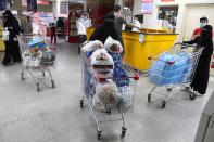 Saudi women push the shopping cart outside a supermarket during shopping in Riyadh