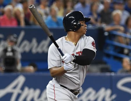 Aug 8, 2018; Toronto, Ontario, CAN; Boston Red Sox third baseman Rafael Devers (11) hits a double against the Toronto Blue Jays in the third inning at Rogers Centre. Dan Hamilton-USA TODAY Sports