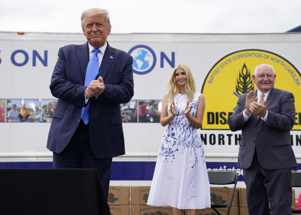 President Donald Trump arrives to deliver remarks on the "Farmers to Families Food Box Program" at Flavor First Growers and Packers, Monday, Aug. 24, 2020, in Mills River, N.C. Ivanka Trump, center and Agriculture Secretary Sonny Perdue, right, applaud. (AP Photo/Evan Vucci)