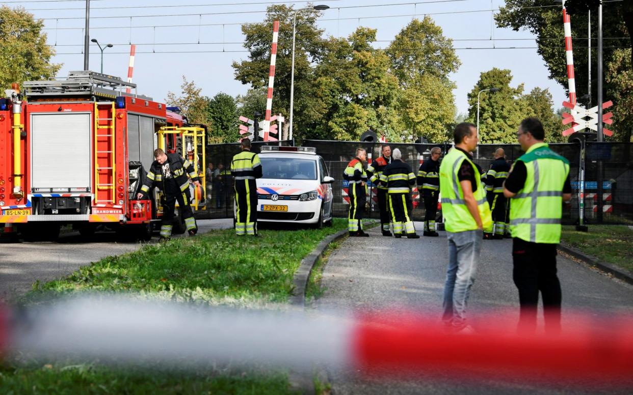 Rescue personnel work at the scene where a train struck a cargo bicycle - REUTERS