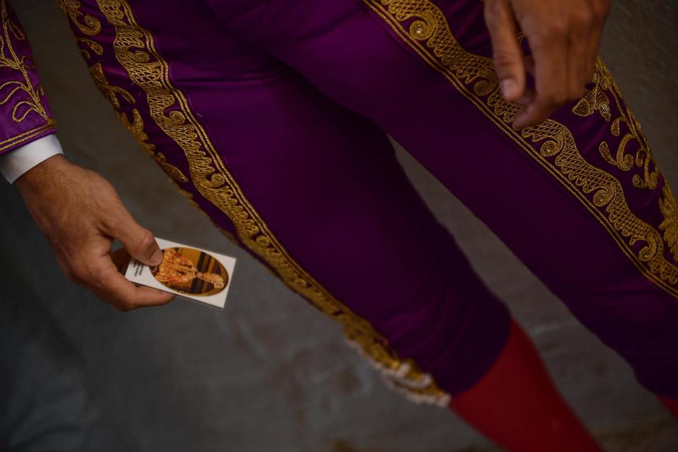 <p>Spanish bullfighter Roberto Garrido holds a card with the image of Saint Fermin before a bullfight at the San Fermin Fiestas in Pamplona, Spain, July 9, 2017. (AP Photo/Alvaro Barrientos) </p>