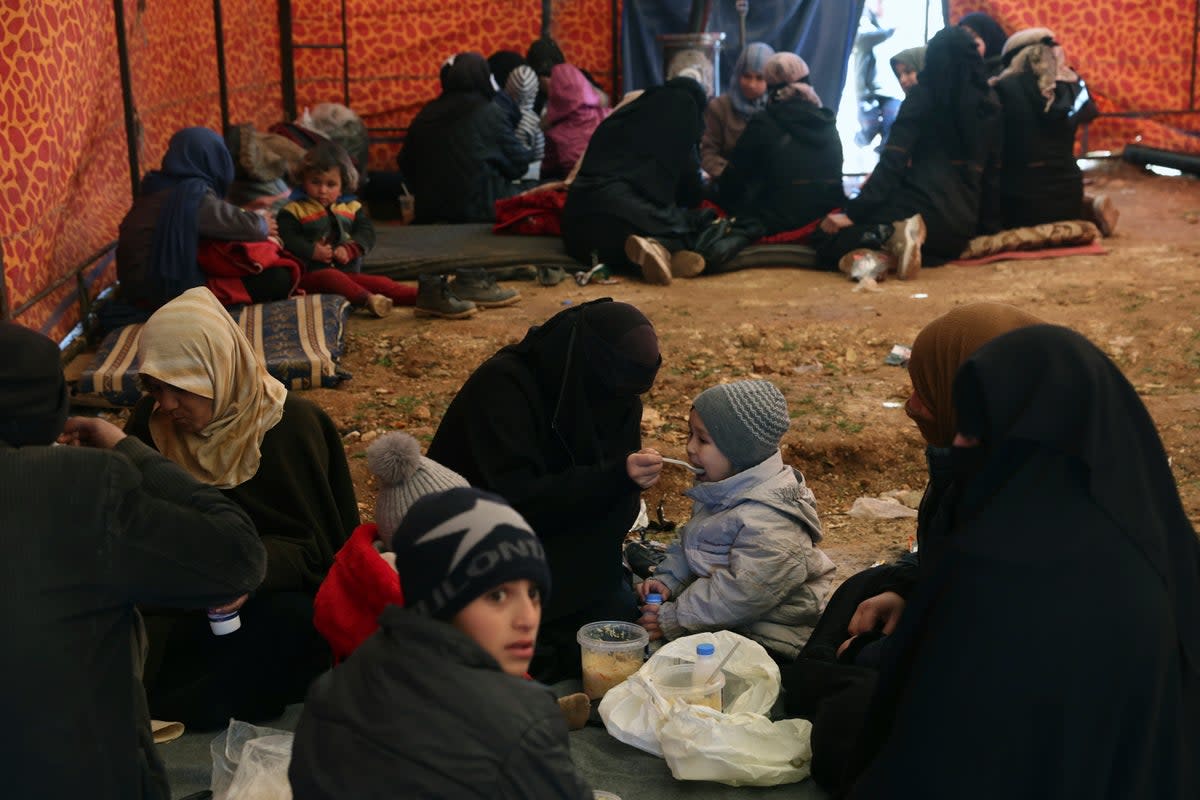 Families who lost their homes in a devastating earthquake in Syria sit inside a tent that an NGO set up (Copyright 2023 The Associated Press. All rights reserved)