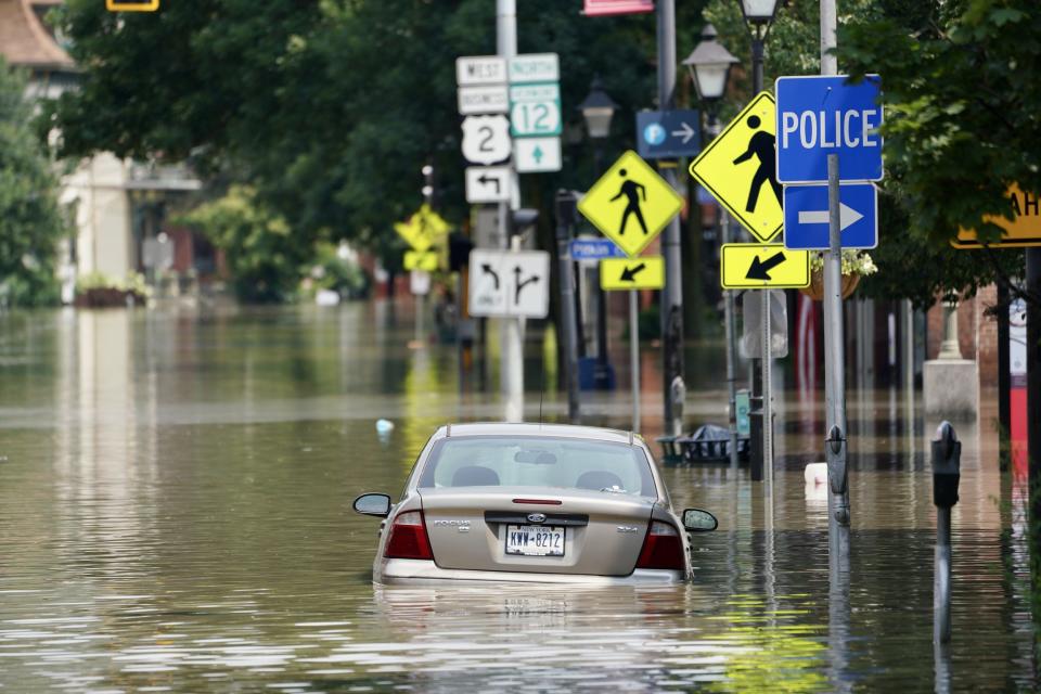 Floodwaters swamped cars and shops in downtown Montpelier, Vermont, on Tuesday.