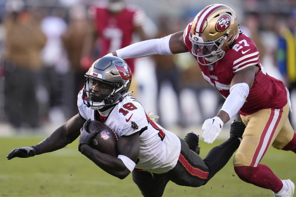 Tampa Bay Buccaneers wide receiver Rakim Jarrett (18) falls after catching a pass in front of San Francisco 49ers safety Ji'Ayir Brown (27) during the second half of an NFL football game in Santa Clara, Calif., Sunday, Nov. 19, 2023. (AP Photo/Godofredo A. Vásquez)