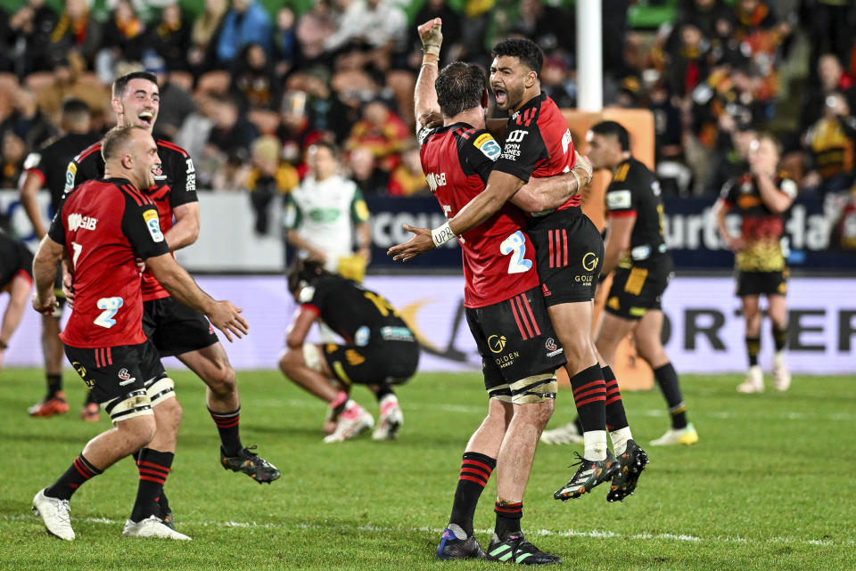 Crusader players celebrate after defeating the Chiefs in the Super Rugby Pacific final between the Chiefs and the Crusaders in Hamilton, New Zealand, Saturday, June 24, 2023. (Andrew Cornaga/Photosport via AP)