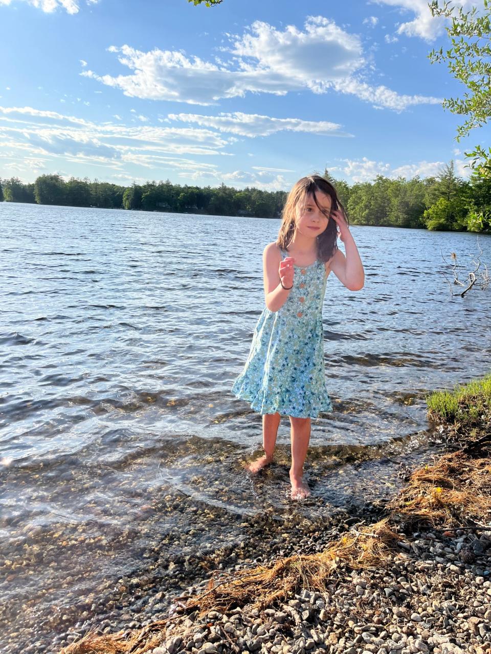 Lucy Morgan, 6, plays in the lake near her family's cottage in Maine. Lucy died on June 5, 2024, several days after a freak accident involving a badminton racket. (Credit: Provided by Jesse Morgan)