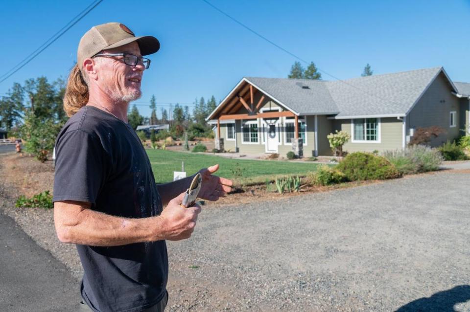 Jim Hafer stands outside his home near Oliver Road in Paradise on Friday. Hafer, whose neighborhood was under an evacuation warning for the Park Fire, said he had already put some of his most valuable possessions in his car in case he needed to leave.