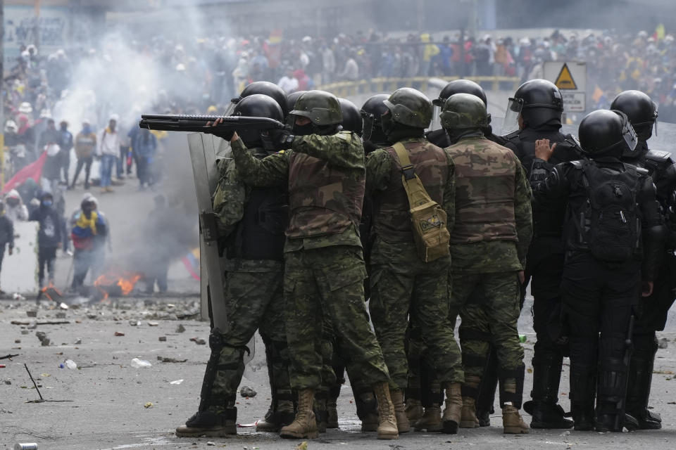 Security forces face demonstrators protesting against the government of President Guillermo Lasso and rising fuel prices, in Quito, Ecuador, Tuesday, June 21, 2022. Ecuador's defense minister warned Tuesday that the country's democracy was at risk as demonstrations turned increasingly violent in the capital. (AP Photo/Dolores Ochoa)