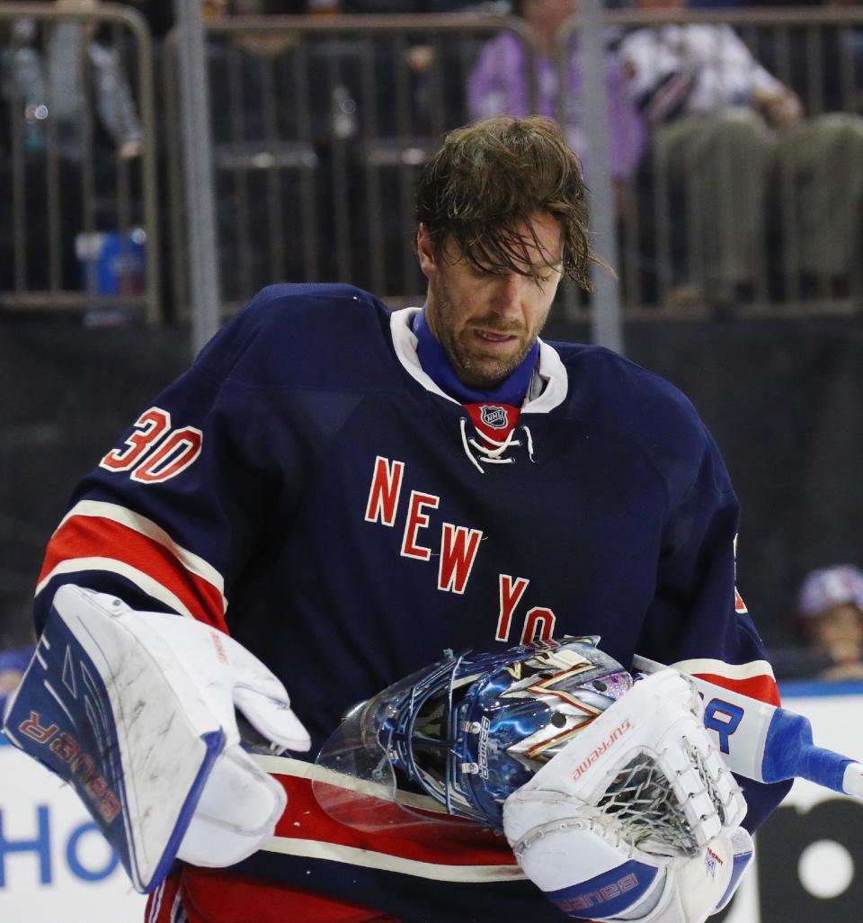 NEW YORK, NY - MARCH 13:  Henrik Lundqvist #30 of the New York Rangers looks at his mask after being hit by a shot by Carl Hagelin #62 during the third period at Madison Square Garden on March 13, 2016 in New York City. The Penguins defeated the Rangers 4-2.  (Photo by Bruce Bennett/Getty Images)