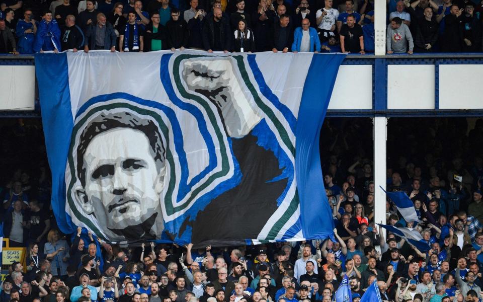 Everton's supporters cheer as they hold a banner picturing Everton's English manager Frank Lampard - AFP