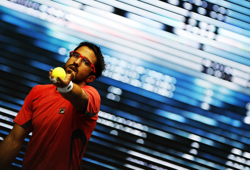 Serbia's Tipsarevic serves to France's Simon during their men's singles semi-final match at the Thailand Open 2012 tennis tournament in Bangkok