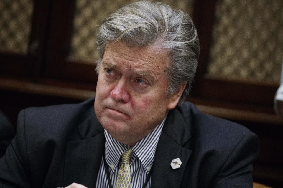 FILE - In this Feb. 7, 2017 file photo, White House chief strategist Steve Bannon listens as President Donald Trump speaks during a meeting with county sheriffs in the Roosevelt Room of the White House in Washington. After saying she’d like to play Bannon on “Saturday Night Live,” Rosie O'Donnell has apparently changed her Twitter profile picture to make herself look like him. O’Donnell’s offer to play Bannon came after actress Melissa McCarthy's caustic portrayal of White House Press Secretary Sean Spicer on “SNL” last Saturday, Feb. 4, 2017. (AP Photo/Evan Vucci)