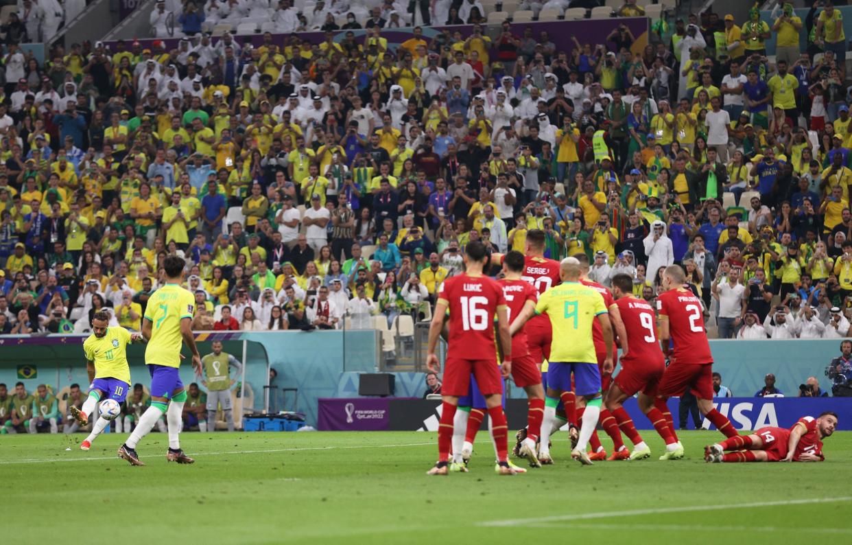 Brazil&#39;s forward #10 Neymar (L) takes a free kick during the Qatar 2022 World Cup Group G football match between Brazil and Serbia at the Lusail Stadium in Lusail, north of Doha on November 24, 2022. (Photo by ADRIAN DENNIS / AFP) (Photo by ADRIAN DENNIS/AFP via Getty Images)