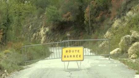 A sign reading: "road closed" stands on a road leading to isolated French villages of Beroulf and Sainte Sabine, in Sospel, France October 17, 2018 in this still image taken from a video on October 19, 2018. Reuters TV/via REUTERS