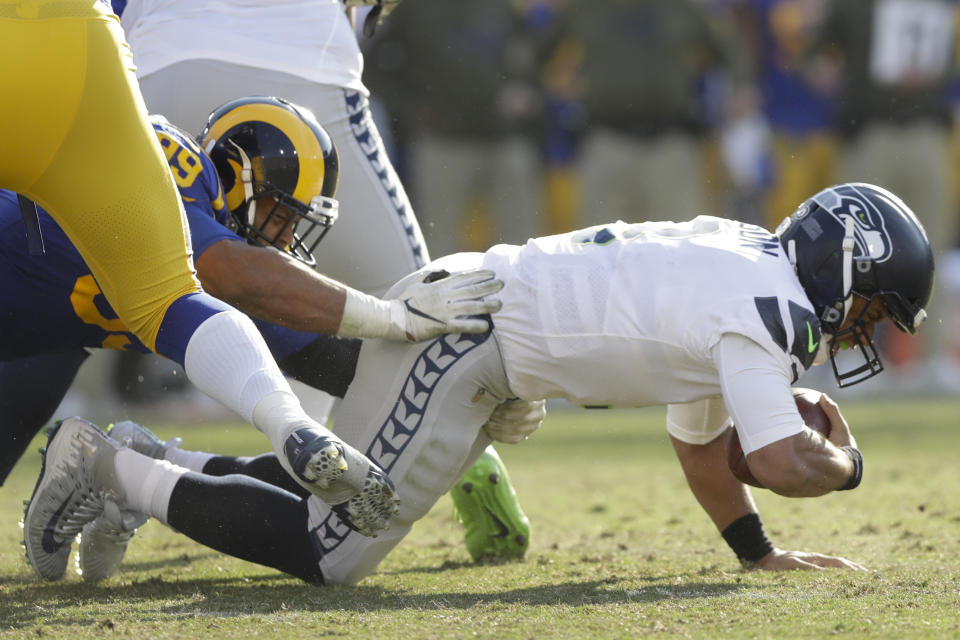 Seattle Seahawks quarterback Russell Wilson, right, gets sacked by Los Angeles Rams defensive end Aaron Donald during the first half in an NFL football game Sunday, Nov. 11, 2018, in Los Angeles. (AP Photo/Alex Gallardo)