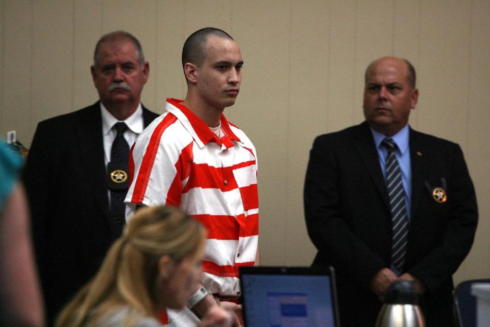 FILE - In this July 20, 2013 file photo, Pvt. Isaac Aguigui of Cashmere, Wash. is lead into a Long County, Ga. court room. A military judge has sentenced Aguigui to life in prison with no chance of parole for the 2011 slaying of his pregnant wife, whose death enabled her husband to pocket (Canadian) $500,000 in insurance and benefit payments. Aguigui of Washington was convicted by a court-martial Thursday March 27, 2014, of murder and causing the death of his unborn child. (AP Photo/Lewis Levine, File)