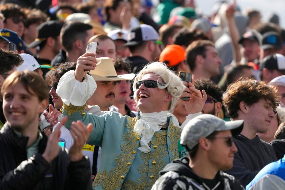 A man dressed as a founding father takes a selfie