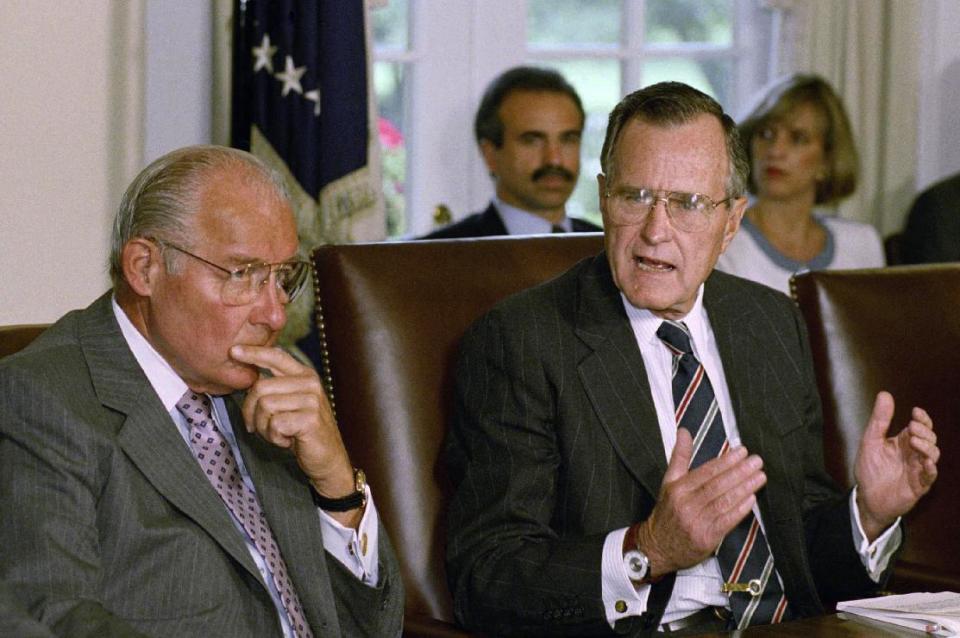 FILE - In this June 9, 1992 file photo, then-House Minority leader Bob Michel of Ill. listens at left as President George H.W. Bush in the Cabinet Room of the White House in Washington. A former aide says Michel has died at age 93. (AP Photo/Dennis Cook, File)