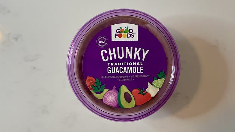 purple container of guacamole