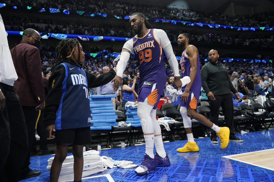 Phoenix Suns forward Jae Crowder (99) greets a Dallas Mavericks fans as he walks off the court after the team's loss in Game 3 of an NBA basketball second-round playoff series, Friday, May 6, 2022, in Dallas. (AP Photo/Tony Gutierrez)