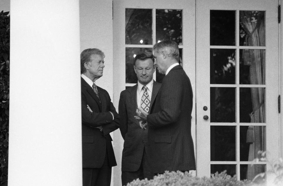 <p>President Carter chats with Secretary of State Cyrus Vance, right, and National Security Adviser Zbigniew Brzezinski outside the White House in Washington on Tuesday, Sept. 11, 1979. The three men confer moments before Carter welcomed an official visitor to the Rose Garden. (Photo: Georges/AP) </p>