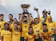 Australia's captain Mile Jedinak (C) holds up the Asian Cup trophy as the team celebrates after winning their Asian Cup final soccer match against South Korea at the Stadium Australia in Sydney January 31, 2015. REUTERS/Tim Wimborne (AUSTRALIA - Tags: SPORT SOCCER TPX IMAGES OF THE DAY)