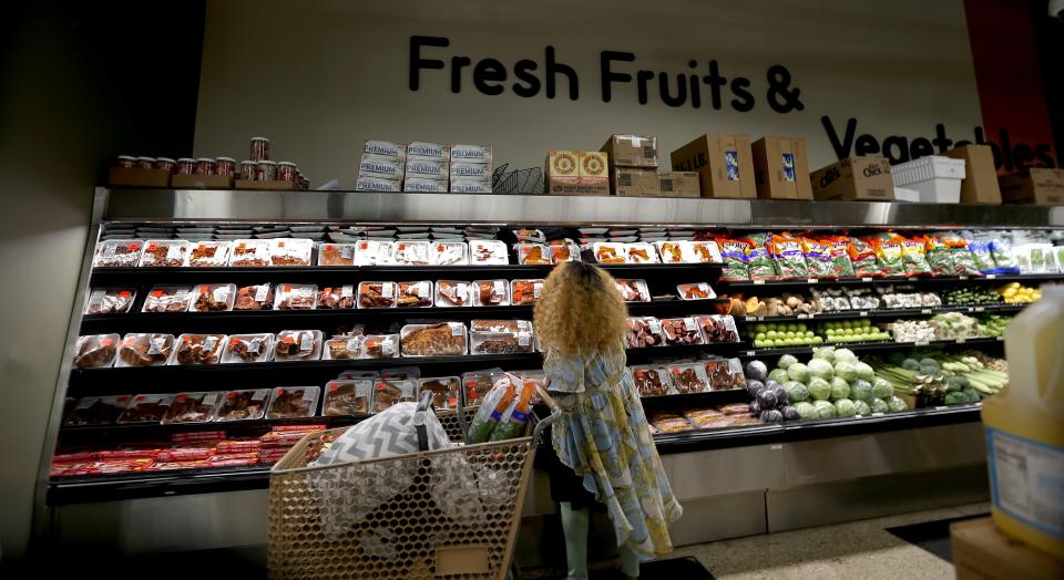 A customer shops at Pete’s Fruit Market in Milwaukee. Children's Wisconsin has a pilot program at its Midtown Clinic in which a physician, or other clinician, can give struggling patients a voucher for food at the grocery store.