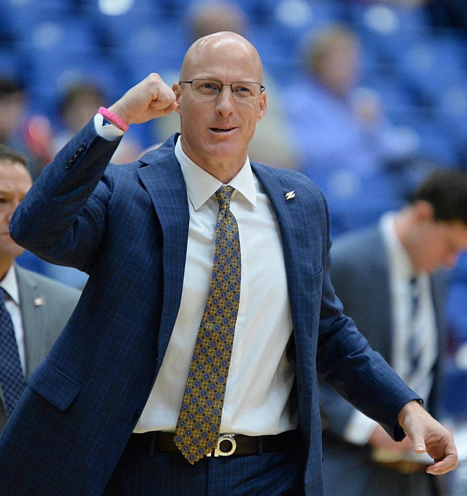 Akron men's basketball coach John Groce pumps his fist after a 3-pointer by Daniel Utomi during the second half against Cedarville at Rhodes Arena, Tuesday, Nov. 6, 2018.