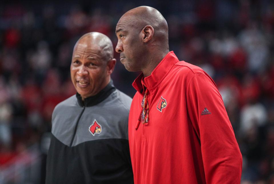 Louisville assistant coach Danny Manning, right, is playing a key role in the development of freshman center Dennis Evans.