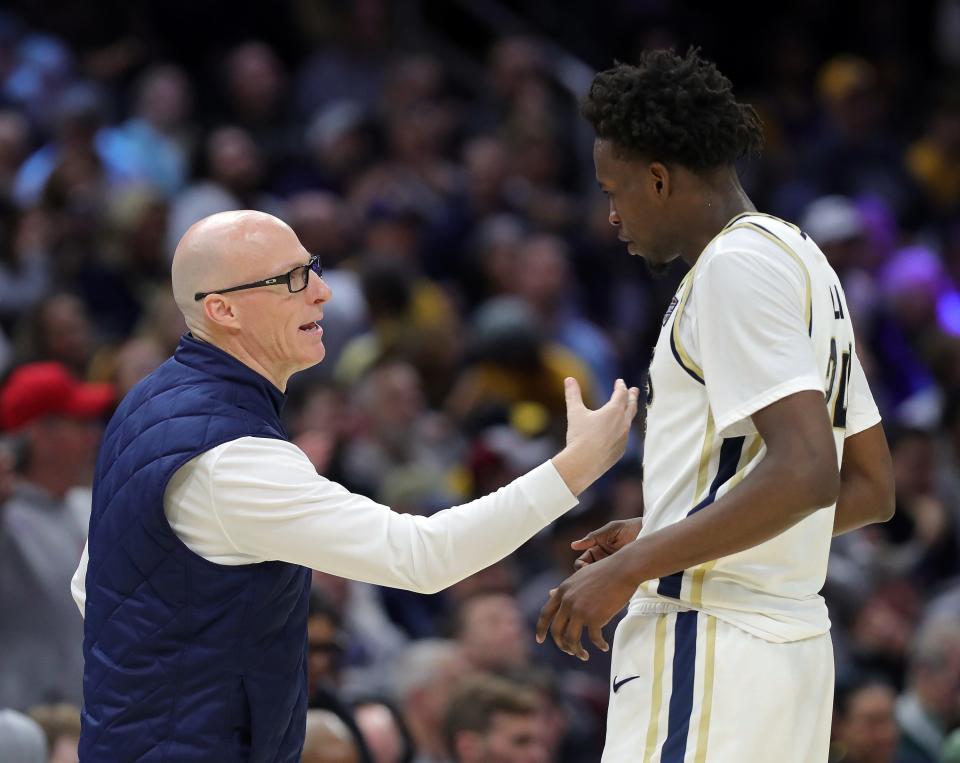 Akron Zips head coach John Groce has a word with Akron Zips guard Ali Ali (24) during the second half of the Mid-American Conference Tournament championship game at Rocket Mortgage FieldHouse, Saturday, March 16, 2024, in Cleveland, Ohio.