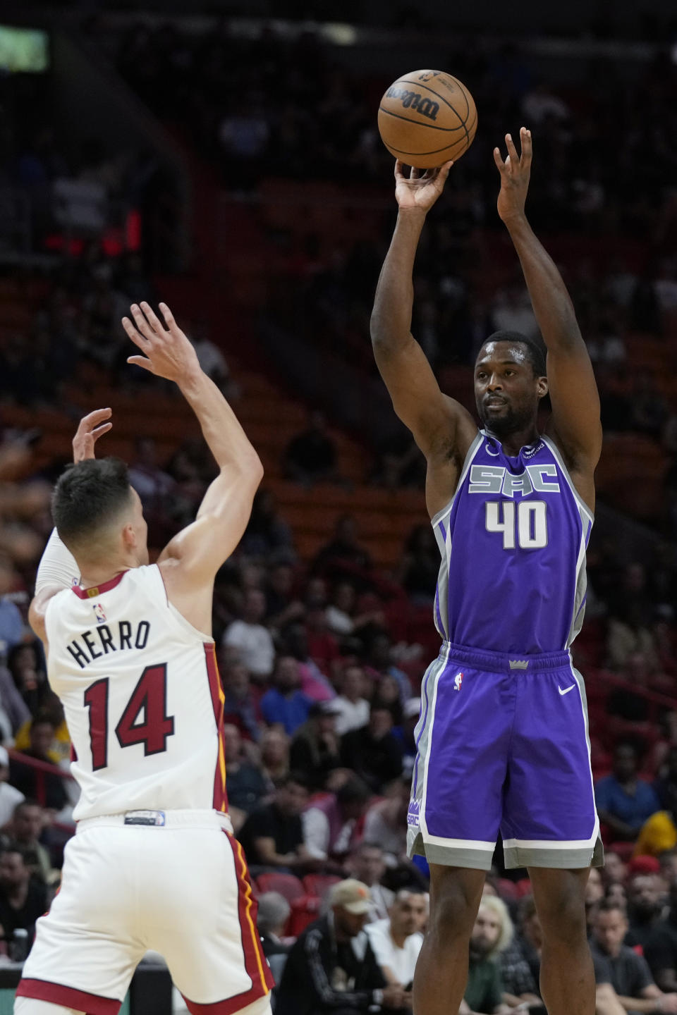 Sacramento Kings forward Harrison Barnes (40) takes a shot against Miami Heat guard Tyler Herro (14) during the first half of an NBA basketball game, Wednesday, Nov. 2, 2022, in Miami. (AP Photo/Wilfredo Lee)