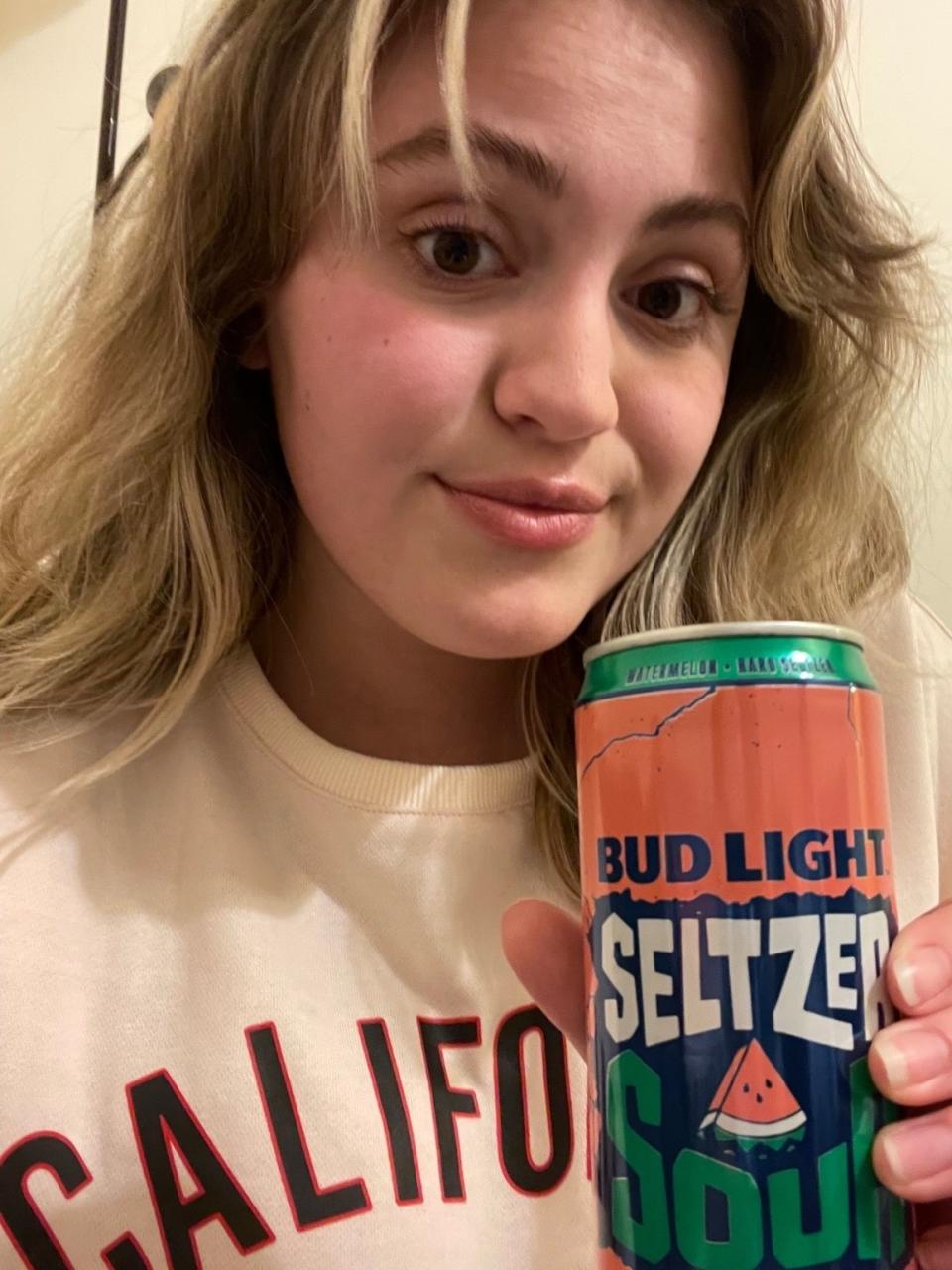 woman holding a seltzer