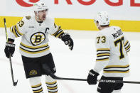 Boston Bruins' Brad Marchand (63) celebrates after his goal against the Toronto Maple Leafs with Charlie McAvoy (73) during second-period action in Game 4 of an NHL hockey Stanley Cup first-round playoff series in Toronto, Saturday, April 27, 2024. (Nathan Denette/The Canadian Press via AP)