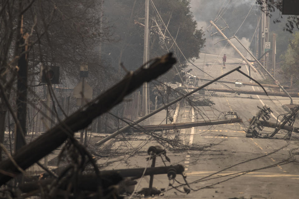 <p>Power poles and lines block a street at Brookdale and Aaron Dr. in Hidden Valley where most of the homes were destroyed by fire on Oct. 9, 2017 in Santa Rosa, Calif. (Photo: Brian van der Brug/Los Angeles Times via Getty Images) </p>