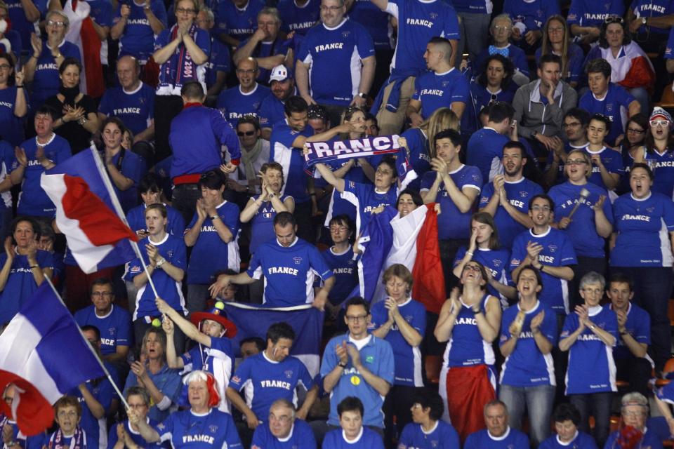 Supporters of France react during the single match between French tennis player Jo-Wifried Tsonga and German player Peter Gojowczyk, in the quarterfinals of the Davis Cup in Nancy, eastern France, Friday April 4, 2014.(AP Photo/Remy de la Mauviniere)