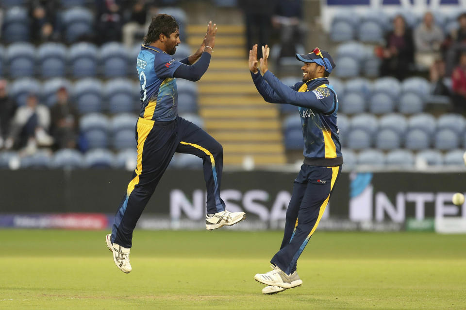 Sri Lanka's Nuwan Pradeep, left, celebrates with Dhananjaya de Silva taking the wicket of Afghanistan's Rashid Khan during the Cricket World Cup group stage match between Sri Lanka and Afghanistan at the Cardiff Stadium, Wales, Tuesday June 4, 2019. (David Davies/PA via AP)