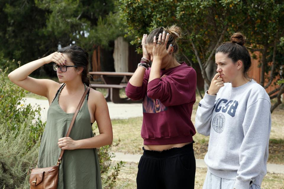 UC Santa Barbara students react near one of the crime scenes after series of drive-by shootings in the Isla Vista section of Santa Barbara