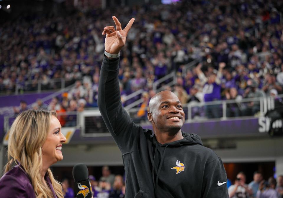 Adrian Peterson salutes the crowd during a 2023 Vikings game.
