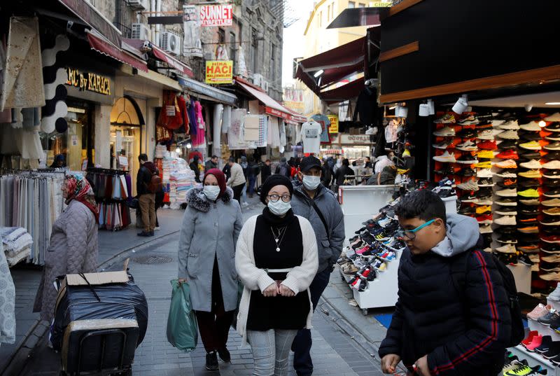 People wear protective face masks due to coronavirus concerns in Istanbul