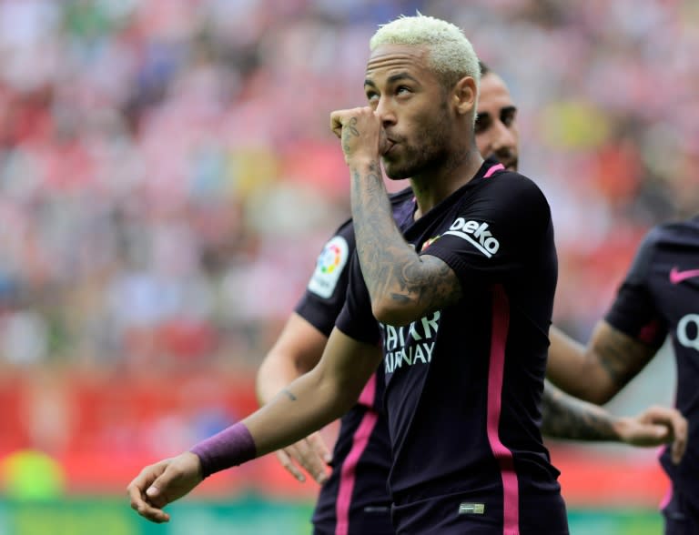 Barcelona's Neymar da Silva Santos Junior celebrates after scoring his team's third goal against Real Sporting de Gijon