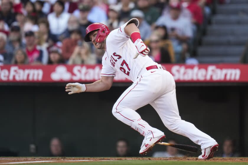 Angels'  Mike Trout runs to first base after hitting a single