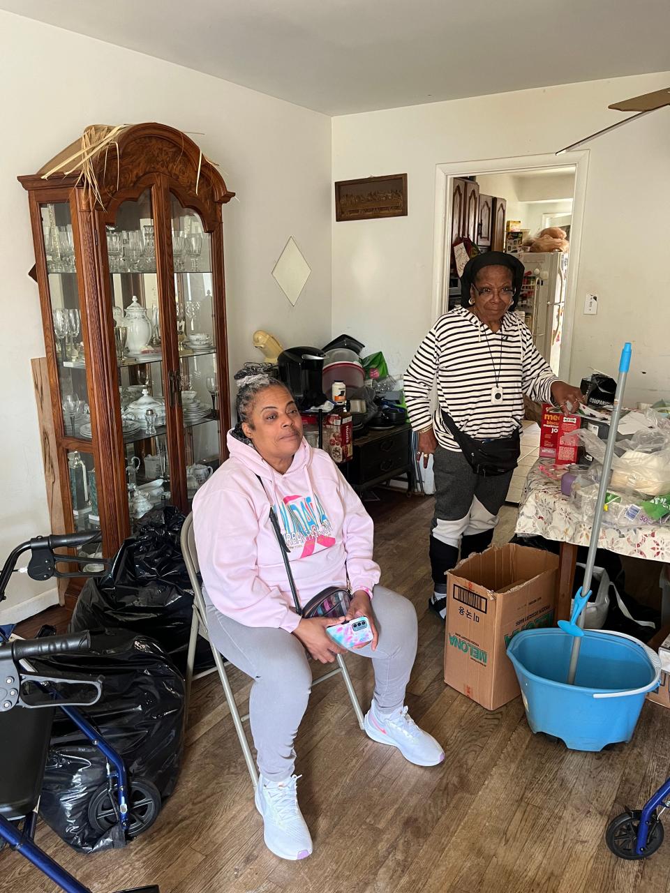 Lisha Quarles and her mother, Marquette Quarles, in the living room of their home in Washington, D.C.