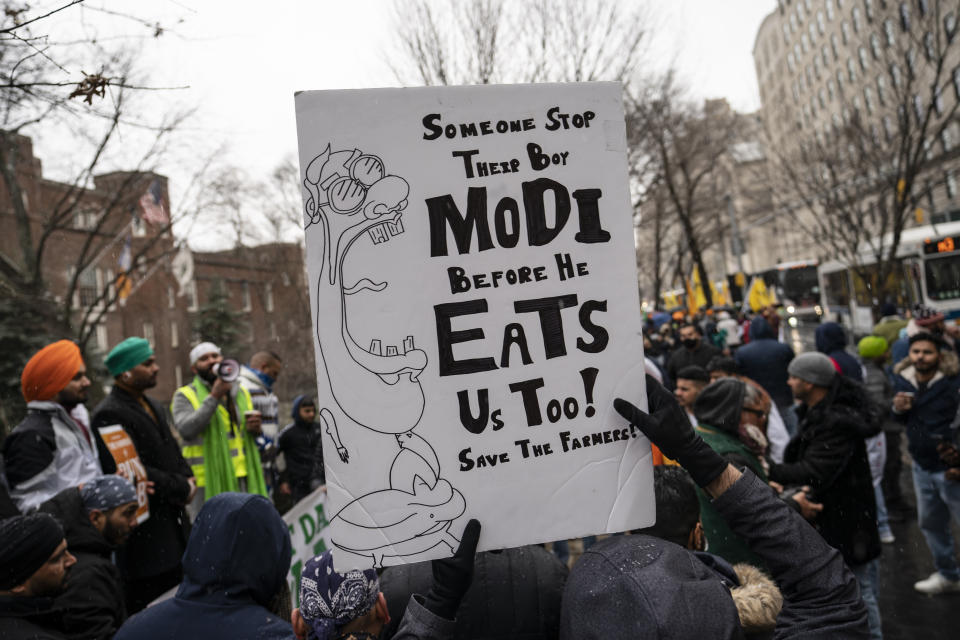 Protesters gather outside the Consulate General of India, Tuesday, Jan. 26, 2021, in the Manhattan borough of New York. Tens of thousands of protesting farmers have marched, rode horses and drove long lines of tractors into India's capital, breaking through police barricades to storm the historic Red Fort. The farmers have been demanding the withdrawal of new laws that they say will favor large corporate farms and devastate the earnings of smaller scale farmers. Republic Day marks the anniversary of the adoption of India’s constitution on Jan. 26, 1950. (AP Photo/John Minchillo)