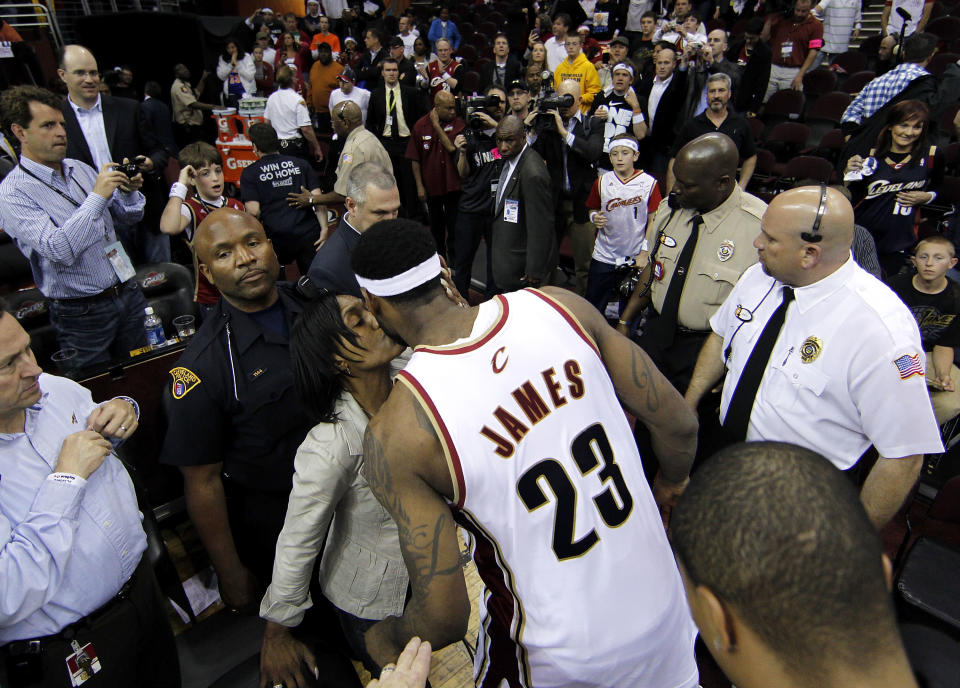 LeBron James #23 of the Cleveland Cavaliers gets a kiss from his mother while leaving the floor after being defeated 120-88 by the Boston Celtics in Game Five of the Eastern Conference Semifinals during the 2010 NBA Playoffs at Quicken Loans Arena on May 11, 2010 in Cleveland, Ohio. NOTE TO USER: User expressly acknowledges and agrees that, by downloading and or using this photograph, User is consenting to the terms and conditions of the Getty Images License Agreement. (Photo by Gregory Shamus/Getty Images)