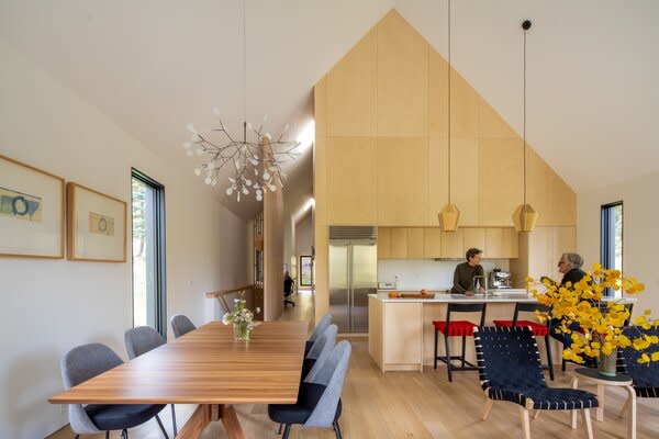 The entryway leads to a common area of a kitchen, dining, and living space.