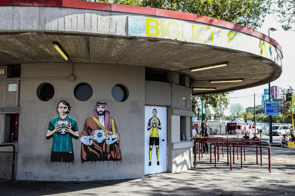 A mural depicting Roberto Mancini, Mohammed bin Salman and Cristiano Ronaldo painted by aleXsandro Palombo outside the San Siro Stadium before the UEFA Champions League match between AC Milan and Newcastle United FC at Stadio Giuseppe Meazza on Sept. 19, 2023 in Milan. (Marco Luzzani / Getty Images)