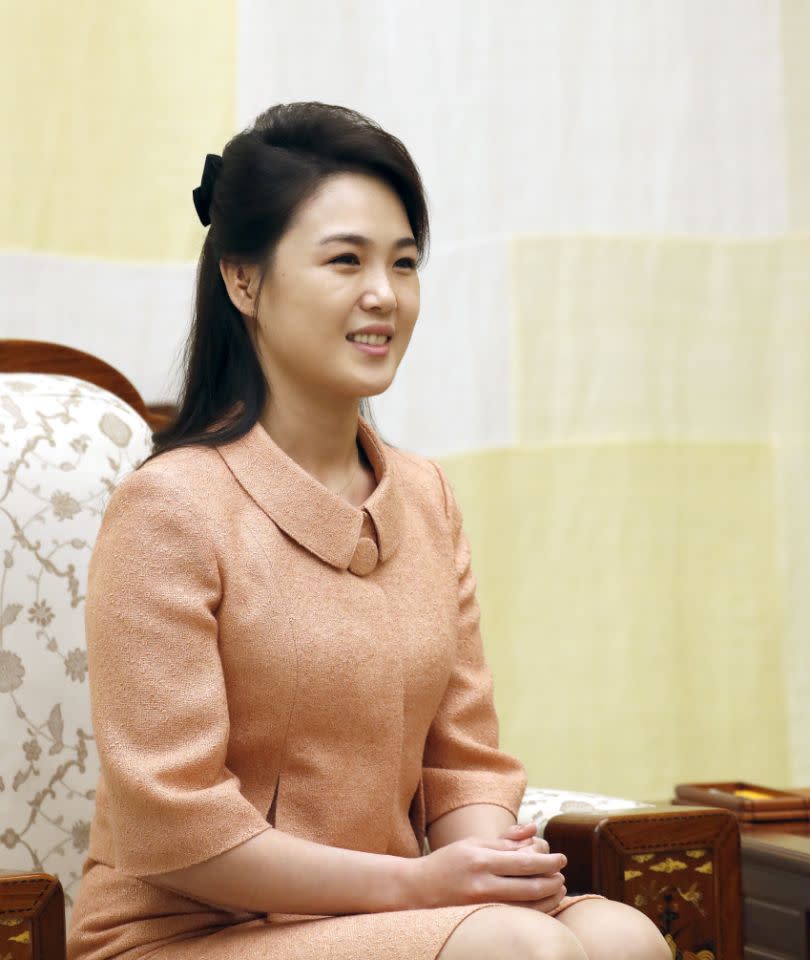 Pictured is Ri Sol-ju smiling while sitting on a chair. 