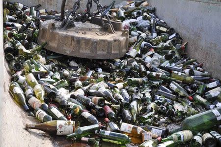 Some of more than 500 bottles of wine found to be counterfeit or unsellable are shown as they are being destroyed at a landfill in Creedmoor, Texas in this December 10, 2015 US Marshals photo. REUTERS/Lynzey Donahue/US Marshals/Handout